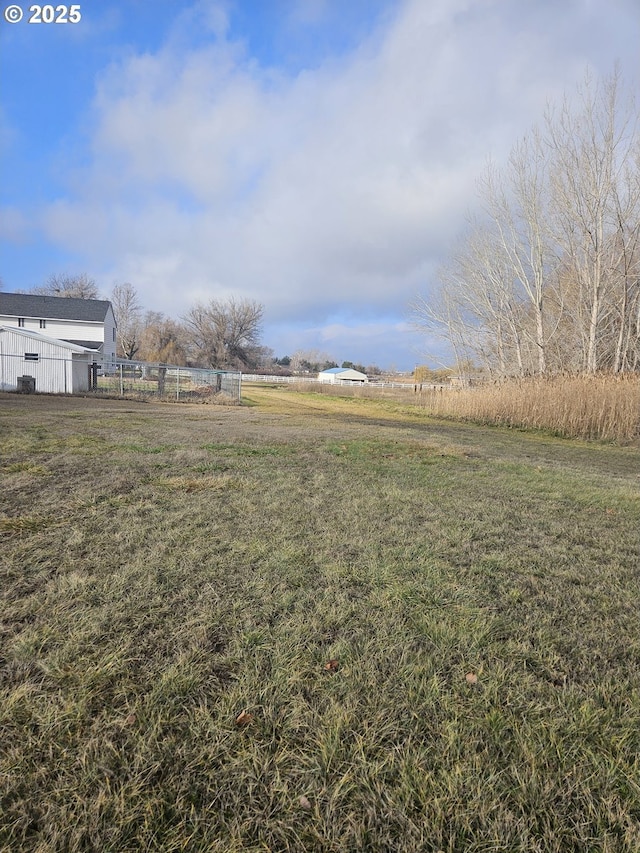 view of yard with a rural view