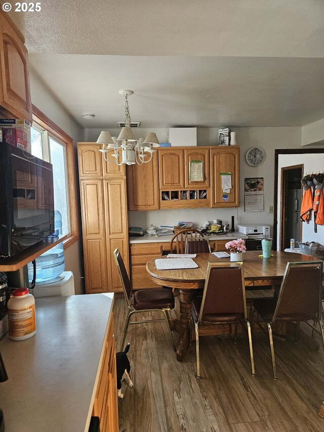 dining area with a notable chandelier and dark hardwood / wood-style floors