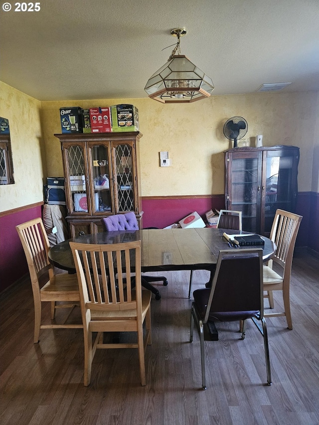 dining space with wood-type flooring