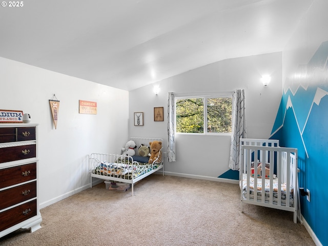 carpeted bedroom featuring a crib and lofted ceiling