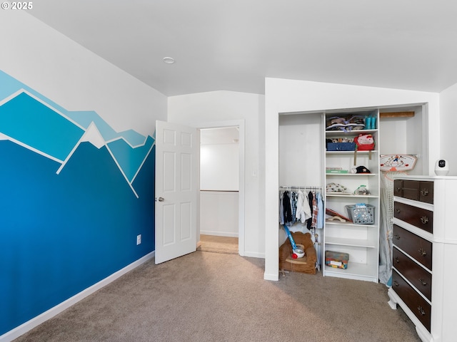 carpeted bedroom featuring lofted ceiling and a closet