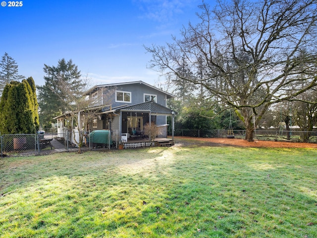 rear view of house featuring a wooden deck and a yard