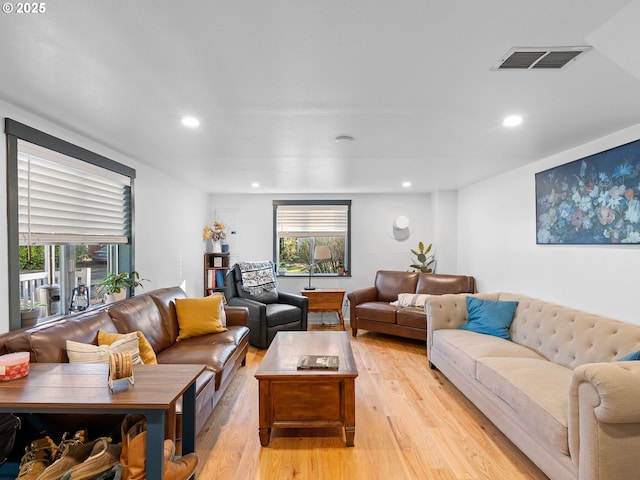 living room featuring plenty of natural light and light hardwood / wood-style floors