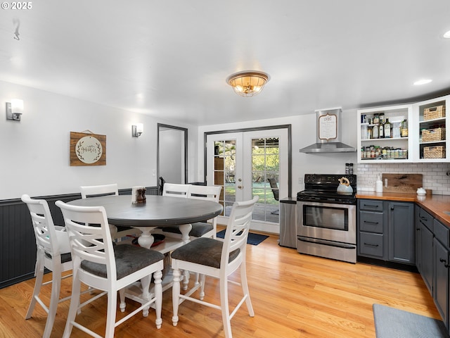 dining area featuring french doors and light wood-type flooring