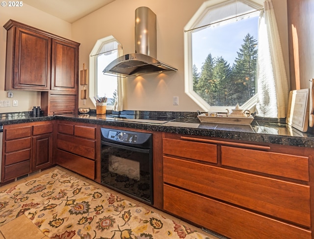 kitchen with light tile patterned flooring, wall chimney exhaust hood, and black appliances