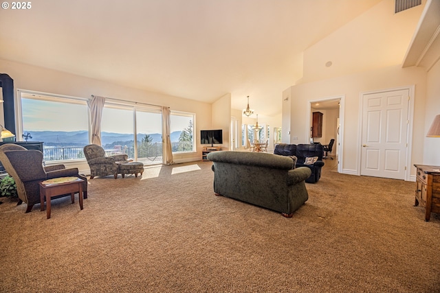 carpeted living room with high vaulted ceiling and a chandelier