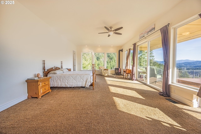 carpeted bedroom with access to exterior, a mountain view, and ceiling fan