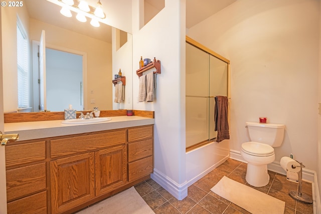 full bathroom with toilet, vanity, and shower / bath combination with glass door