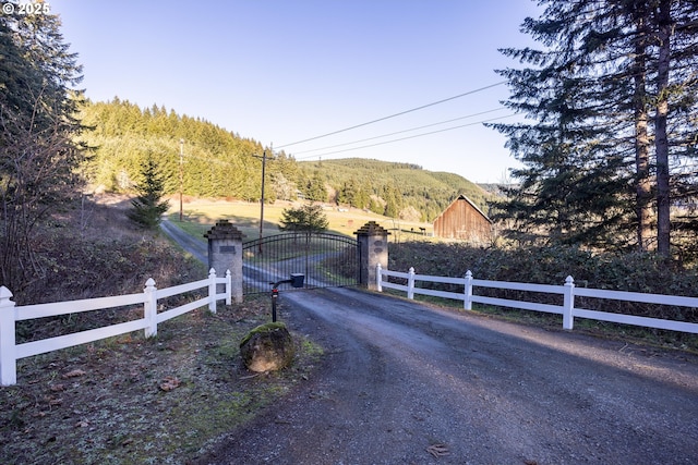 view of street with a rural view and a mountain view