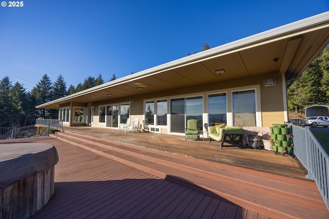 deck featuring a hot tub