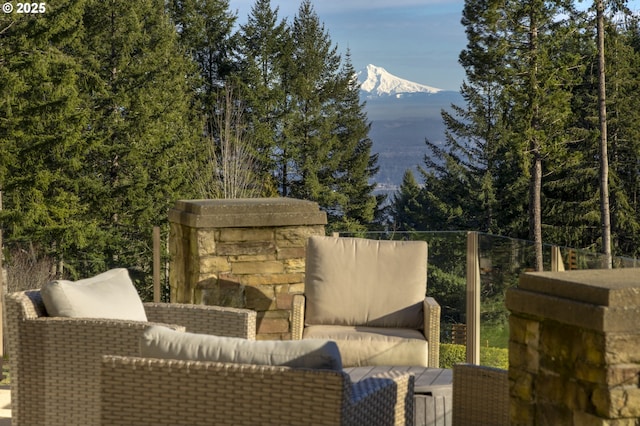 wooden deck featuring a mountain view and an outdoor living space