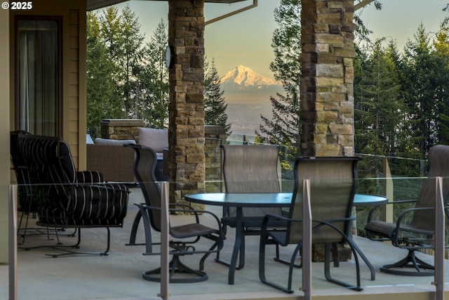 balcony at dusk featuring a patio area