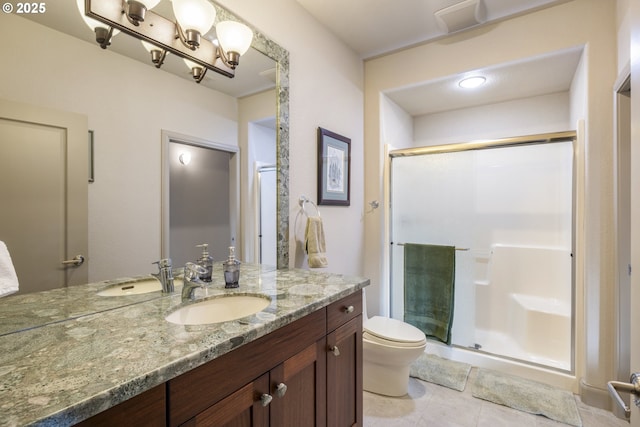 bathroom featuring a shower with door, tile patterned flooring, vanity, and toilet