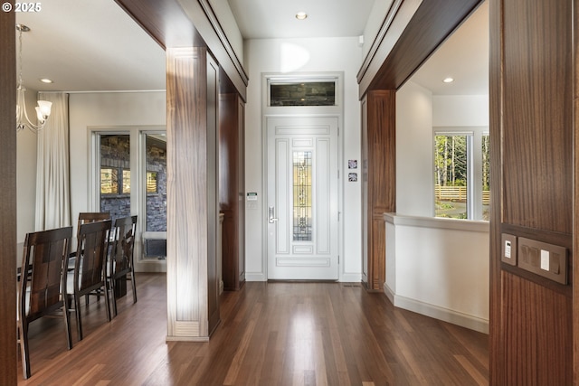 doorway to outside with dark wood-type flooring and decorative columns