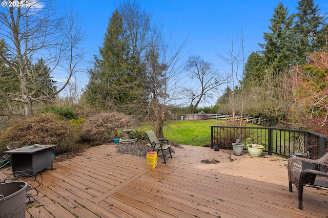 deck featuring a yard and fence