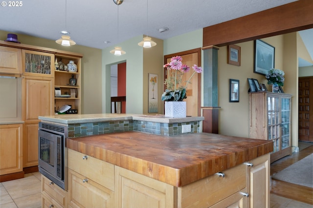 kitchen featuring light tile patterned floors, wooden counters, open shelves, built in microwave, and light brown cabinetry