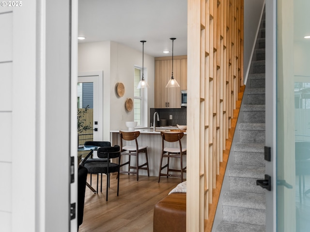 staircase featuring recessed lighting and wood finished floors