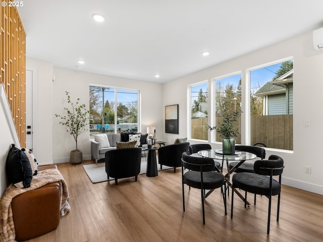 dining area featuring recessed lighting, wood finished floors, and baseboards