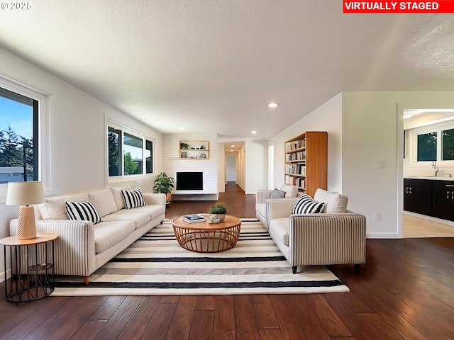 225 SE Hacienda Ct, Gresham, OR 97080 - living room featuring recessed lighting, baseboards, a large fireplace, and hardwood / wood-style flooring