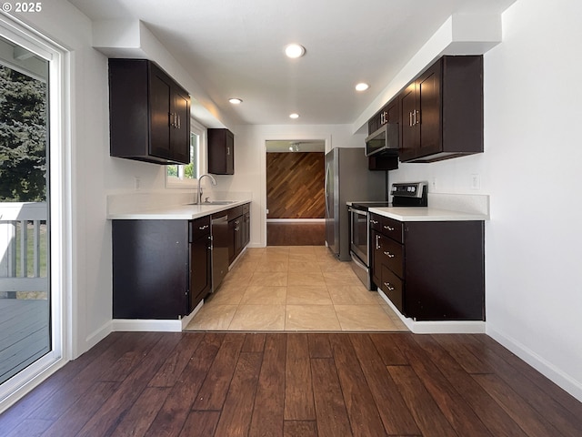 225 SE Hacienda Ct, Gresham, OR 97080 - kitchen with a sink, light countertops, baseboards, light wood-style floors, and stainless steel appliances