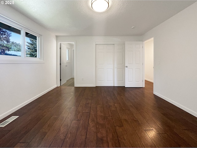 225 SE Hacienda Ct, Gresham, OR 97080 - unfurnished bedroom featuring baseboards, dark wood-style flooring, and visible vents