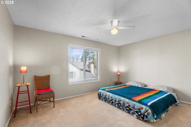 carpeted bedroom with a textured ceiling and ceiling fan