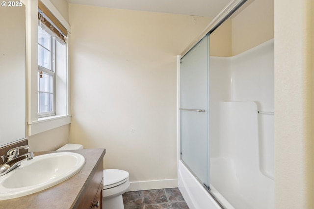 full bathroom with toilet, baseboards, combined bath / shower with glass door, and vanity