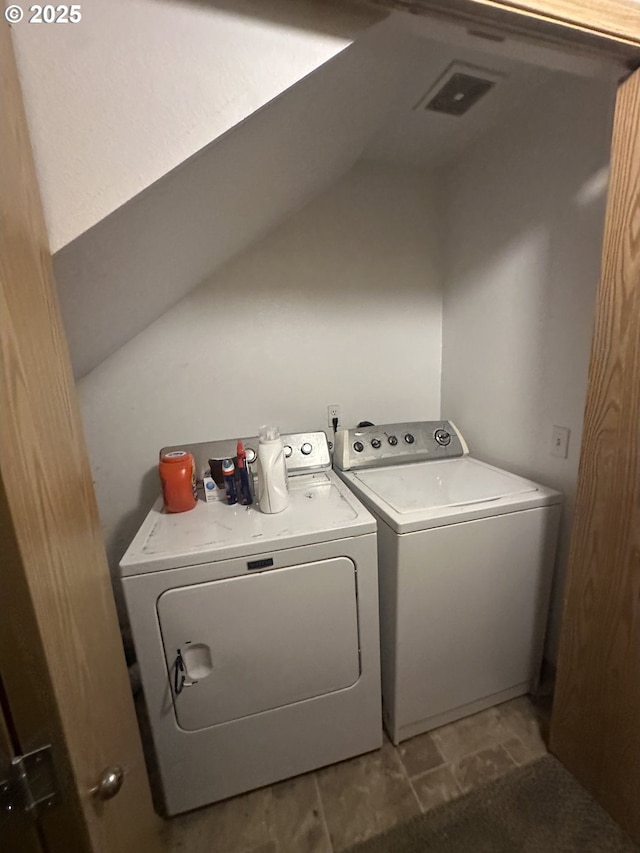 washroom featuring washing machine and dryer and laundry area