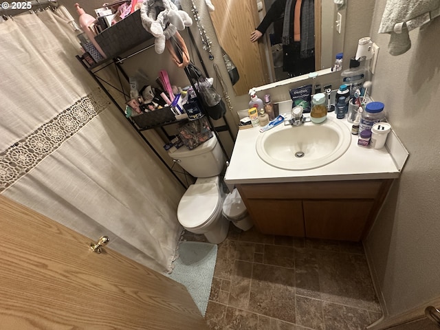 bathroom featuring vanity and toilet