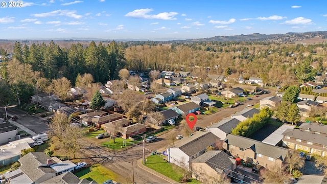 birds eye view of property featuring a residential view and a view of trees