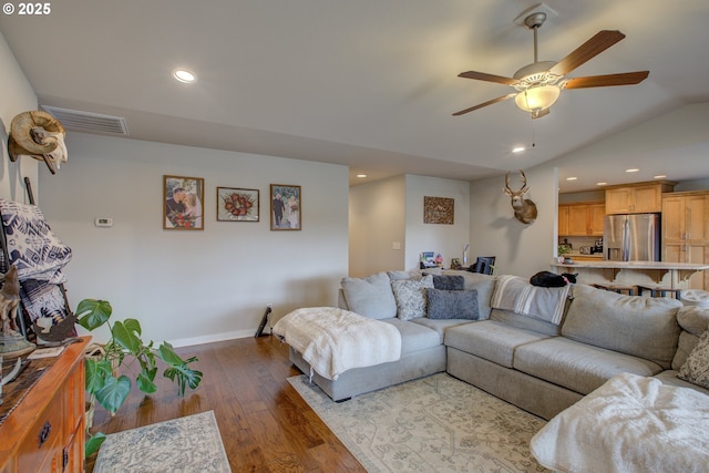 living room with lofted ceiling, ceiling fan, and light hardwood / wood-style flooring