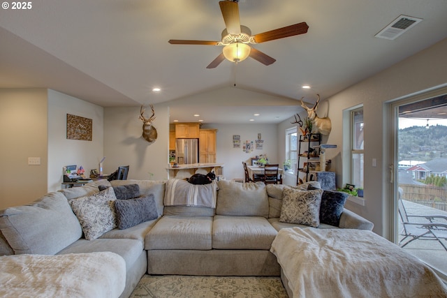 living room featuring lofted ceiling and ceiling fan