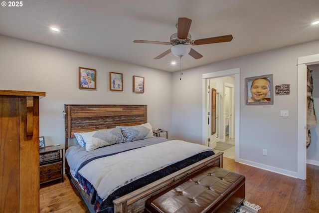 bedroom featuring ensuite bathroom, hardwood / wood-style floors, and ceiling fan