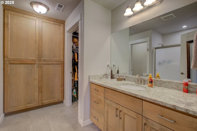 bathroom with vanity and walk in shower