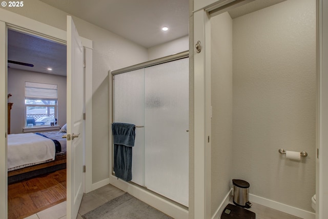 bathroom featuring hardwood / wood-style floors and an enclosed shower