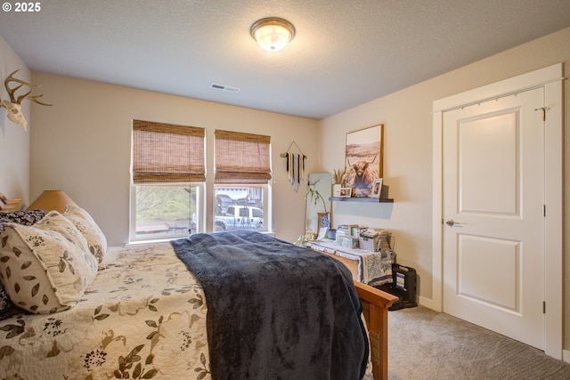 carpeted bedroom with a textured ceiling