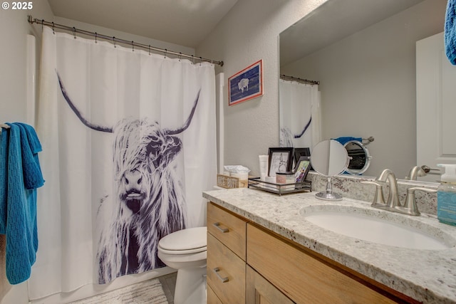 bathroom with toilet, a shower with curtain, vanity, and tile patterned flooring