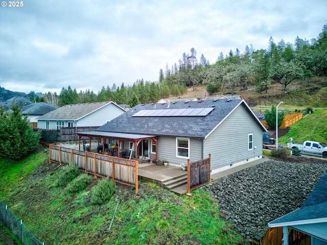 back of house with solar panels