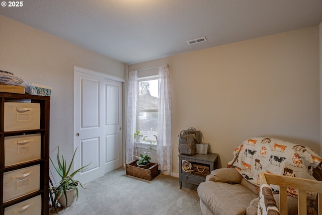 sitting room featuring light colored carpet