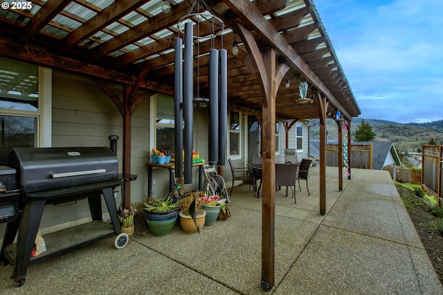 view of patio / terrace with a pergola, a grill, and a mountain view