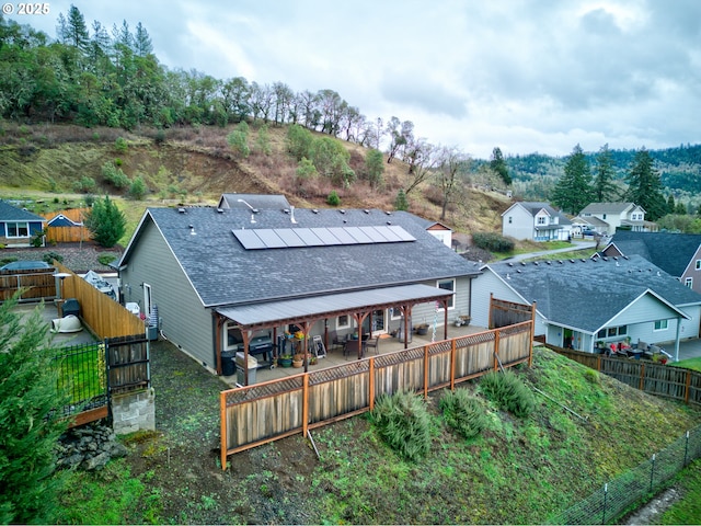 rear view of house featuring solar panels