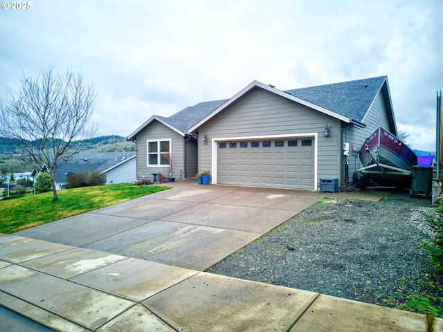 view of front of home with a front yard and a garage