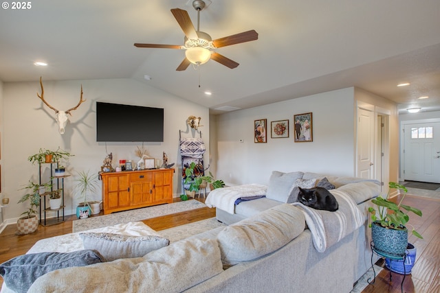 living room featuring vaulted ceiling, ceiling fan, and wood-type flooring