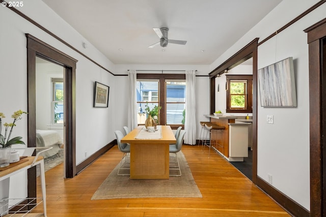dining area with ceiling fan, wood finished floors, and baseboards