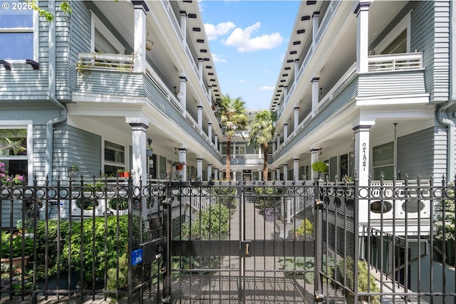 view of home's community featuring a gate and fence