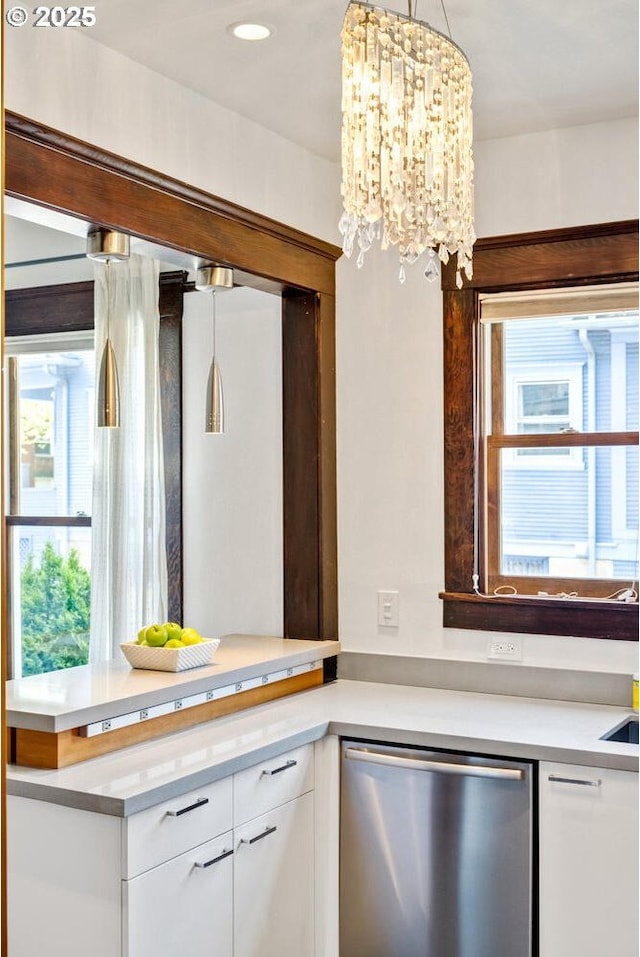 kitchen featuring stainless steel dishwasher, white cabinetry, light countertops, plenty of natural light, and recessed lighting