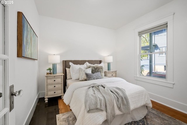 bedroom with wood finished floors and baseboards