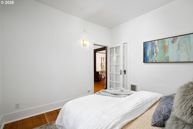 bedroom with wood finished floors and baseboards