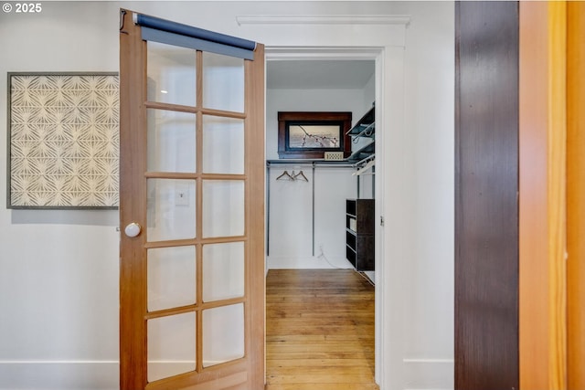 spacious closet featuring wood finished floors