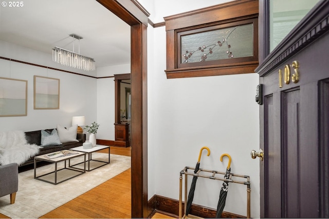 hallway with light wood finished floors and baseboards